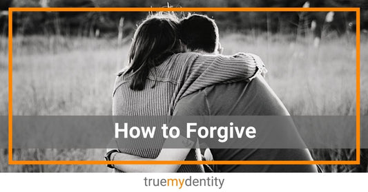 couple sitting on dock hugging talking working on how to forgive each other