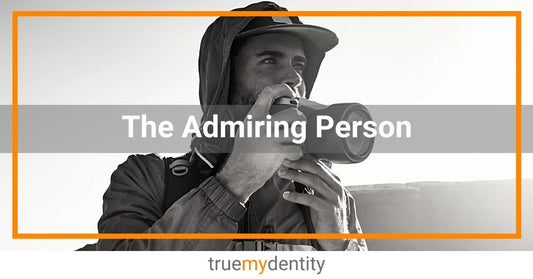 young male hiker photographer holding camera wearing jacket hoodie cap backpack admiring scenery True Mydentity