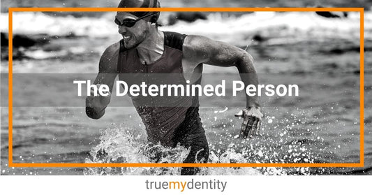 determined male triathlete grimacing while running through shallow water True Mydentity