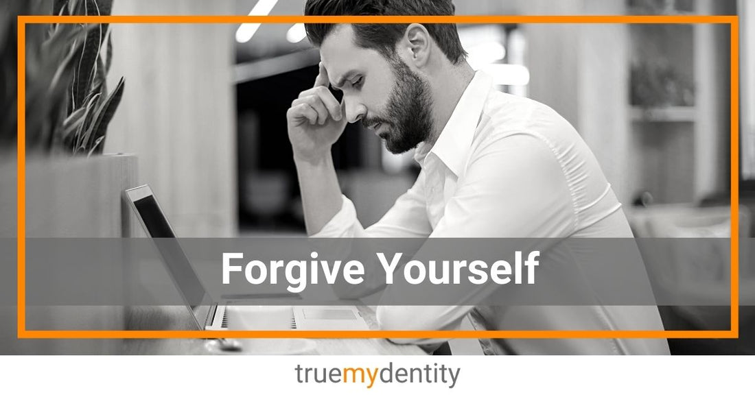 young man sitting at coffee shop counter with laptop eyes closed thinking about how to forgive himself