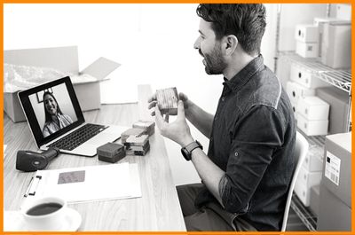 young man curious new employee on laptop asking team leader on video chat about product line ingredients